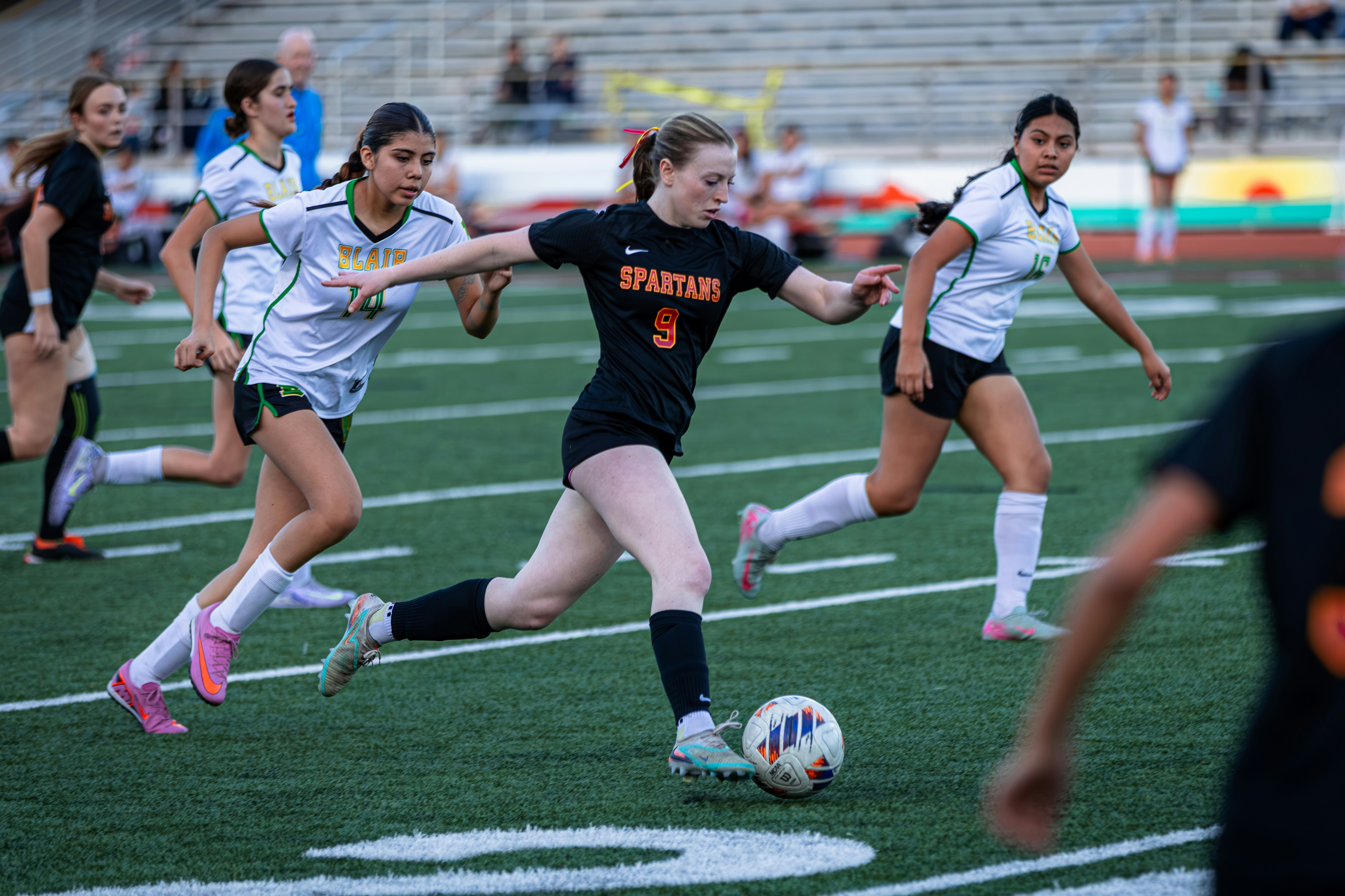 High school soccer players competing on the field